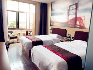 a hotel room with two beds and a large window at Thank Inn Chain Hotel hebei baoding qingyuan district vocational education center in Baoding