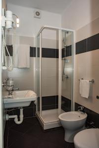 a bathroom with a toilet, sink, and shower at Hotel Principe in Sanremo