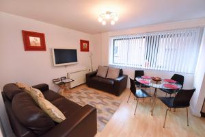 a living room with a couch and a table at Dreamhouse Apartments Manchester City Centre in Manchester