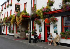 a group of people sitting outside of a building at Bush Hotel in Carrick on Shannon