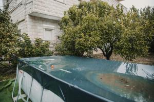 a hot tub with a tarp on it in a yard at The Garden apartment in Nazareth