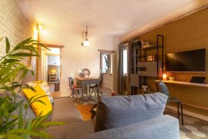 a living room with a couch and a tv and a table at La casa di Giò - Bio Appartamento in Osimo