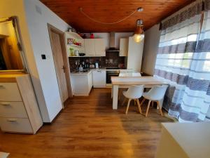 a kitchen with a table and chairs in a room at Snežak (Snowman) 2 in Bohinj