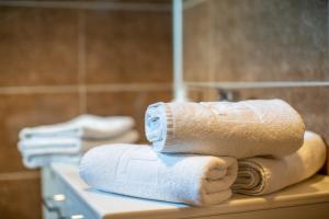 a pile of towels sitting on top of a bathroom sink at So&sol boutique Hotel, Tuzla in Tuzla +36 photos