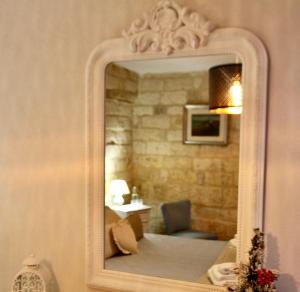 a mirror on the wall of a bathroom at La Stanza in Bari