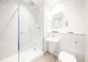 a bathroom with a shower and a toilet and a sink at Toby Carvery Exeter M5 J30 by Innkeeper's Collection in Exeter