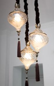 a pair of glass chandeliers with tassels at Georgia Pelekanou Studios in Fira