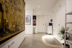 a room with a large painting on the wall and a hallway at My place in Rome