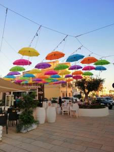 - un bouquet de parasols colorés suspendus au-dessus d'une terrasse dans l'établissement La casuzza sul molo, à Mazara del Vallo