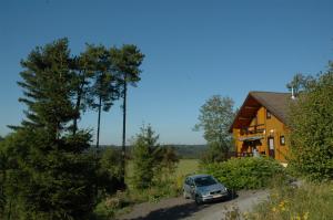 a car parked in front of a house at Chalet Le Mirador in Durbuy