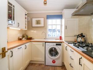 a kitchen with a washing machine in the middle at 1 The Cross in Dunkeld