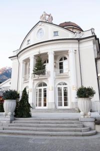 a large white building with stairs in front of it at City Apartments Portico in Merano