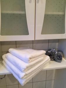 a pile of towels sitting on a shelf in a bathroom at Königlicher Aufenthalt inmitten der Natur in Hürth
