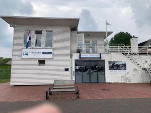 a building with a bench in front of it at Marinaparcs Naarden in Naarden