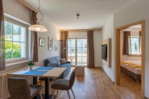 a living room with a couch and a table at Apartments Villa Majense in Merano