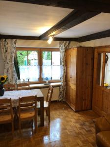 a dining room with a table and chairs and windows at Ferienhaus Karin in Schönabrunn