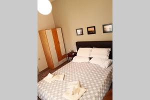 a bedroom with a bed with towels on it at Ellis Apartments , Amperia , Crete in Chania Town