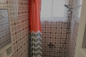 a shower in a bathroom with a shower curtain at Ellis Apartments , Amperia , Crete in Chania Town
