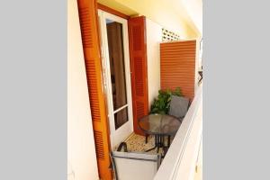 a balcony of a house with a table and a window at Ellis Apartments , Amperia , Crete in Chania Town