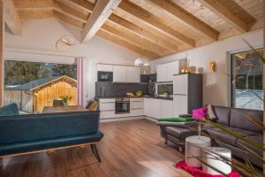 a living room with a couch and a kitchen at Appartement Ahorn in Ramsau am Dachstein