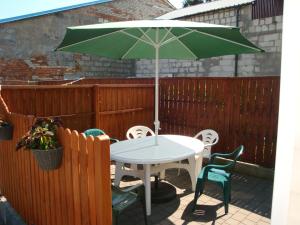 - une table et des chaises avec un parasol sur la terrasse dans l'établissement Lucy, à Władysławowo