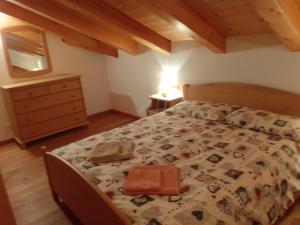 a bedroom with a bed with a purse on it at Casa Dai Fre' CIPAT ZERO22018-AT-ZERO53006 in Bocenago