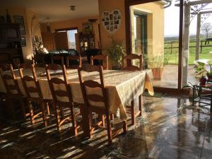 a dining room table and chairs in a room at La Bretonniere in Dragey +49 photos