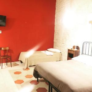 Postel nebo postele na pokoji v ubytování Palazzo Lupicini Affittacamere