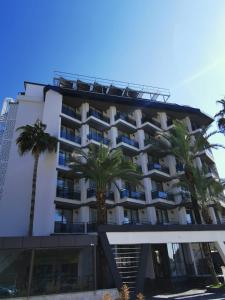 un hotel con palmeras delante en Sette Serenity Hotel en Alanya