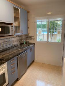 A kitchen or kitchenette at First Line Cabo Roig Orihuela Costa
