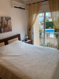A bed or beds in a room at First Line Cabo Roig Orihuela Costa