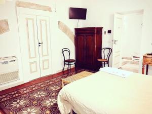 Postel nebo postele na pokoji v ubytování Palazzo Lupicini Affittacamere