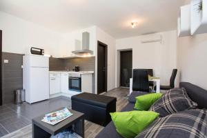 a living room with a couch and a kitchen at Villa Mia in Dubrovnik