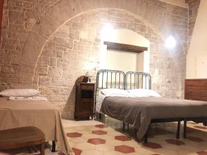 Postel nebo postele na pokoji v ubytování Palazzo Lupicini Affittacamere