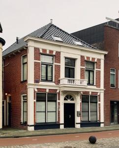 a red brick building with a white trim at Luxurious two bedroom apartment A kwartier Center in Groningen