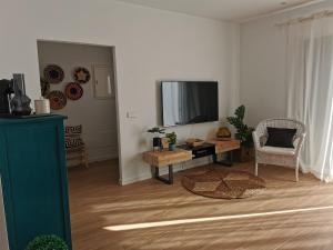 a living room with a television and a table at Villa Bahía in Port de Pollensa