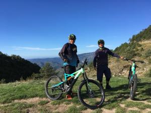 two men standing on a hill with their bikes at Gite des remparts in Lucéram