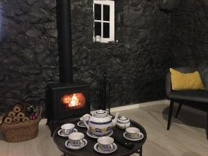 a fireplace in a living room with a stove at GRANARY'S HOUSE in Sete Cidades +7 photos