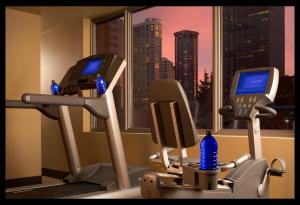 a desk with two monitors and two chairs at Pan Pacific Seattle in Seattle