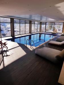 a large swimming pool in a large building at Mylaon Boutique Hotel & Spa in Vitina