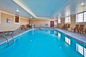 a swimming pool with blue water in a building at Holiday Inn Express Hotel & Suites Wabash, an IHG Hotel in Wabash