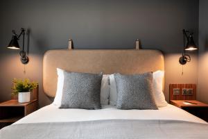 a bedroom with a large bed with two pillows at The Gate London City in London