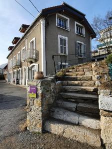 a building with stone steps in front of a house at La fontaine des amis in Gap