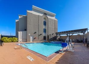 a large swimming pool in front of a building at Holiday Inn Express Hotel and Suites Bastrop, an IHG Hotel in Bastrop