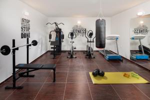 a gym with weights and equipment in a room at Vacation villa Matic with 7 bedrooms in Sinj
