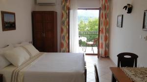 a bedroom with a bed and a door to a balcony at Villa Agava in Vrboska
