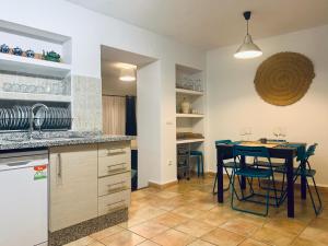 a kitchen with a table and a dining room at Casa Marina in Frigiliana