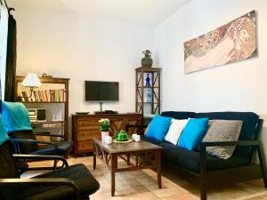 sala de estar con sofá azul y mesa en Casa Marina, en Frigiliana