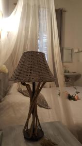 a wooden lamp in a bedroom with a bed at Fonda Felip in Port de la Selva