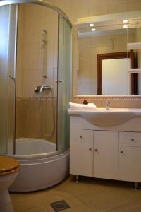 a bathroom with a sink and a shower and a toilet at Villa Agava in Vrboska